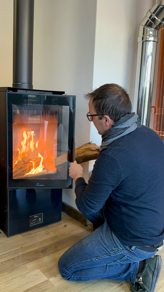 Luigi Visonà mentre accende una stufa a legna nel suo showroom di Brendola